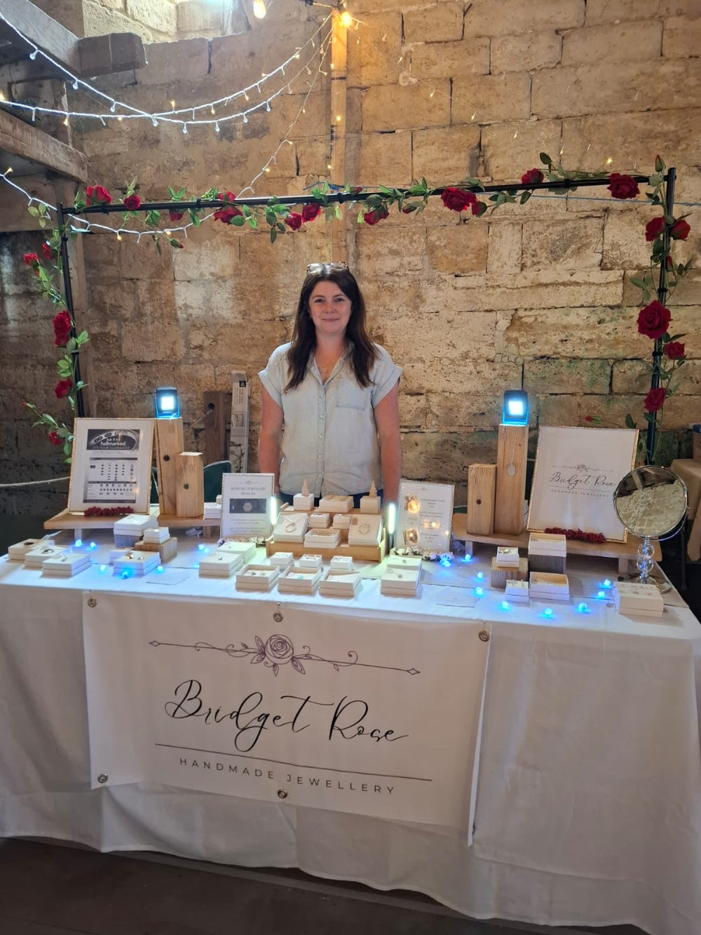 Sian owner & designer of Bridget Rose Jewellery with her display of handmade jewellery at Abbotsbury Flower Festival in Dorset, UK